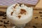 Bowl of hominy Canjica on a wooden tray