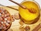 Bowl with honey and basket with hazelnuts on wooden table