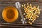 Bowl with honey, honey dipper, puffed wheat on wooden table. Top view