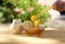 Bowl of honey and sugar and lemons on wooden table