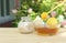 Bowl of honey and sugar and lemons on wooden table