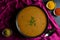 A bowl of hot Indian curry on black background