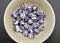 A bowl with humbug balls against a plain background