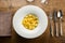 Bowl of Italian cappelletti pasta near napkin and silverware