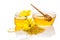 The bowl and the jar of honey near a pile of pollen and flower