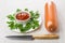 Bowl with ketchup, parsley in plate, sausage in shell, knife