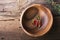 Bowl made of wood with simple wooden rustic background red peppers and sharp beam thyme tied cotton twine. View from