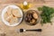 Bowl with marinated mushrooms, bread, vegetable oil, fork and di