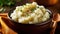 Bowl of mashed potatoes on a wooden table