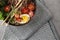 A bowl of meat soup with tomatoes, egg, herbs, noodles and sesame. macro photo of food