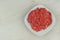 Bowl of mince on wooden background. Homemade minced meat comes out of the meat grinder. Cooking a burger.