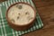 A bowl of moldy yogurt on wooden table