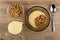 Bowl with muesli, yogurt, jug of yogurt, bowl with granola, spoon on table. Top view