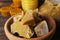 Bowl with natural beeswax blocks on wooden table, closeup