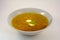 A bowl of noodle soup with sour cream on white background