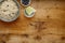 A bowl of nutritious blueberry and apple porridge and a small bowl of blueberries and apple, on a wooden background, withcopy