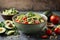 Bowl of nutritious vegan food avocado quinoa tomato cucumber veggie salad.