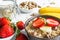 Bowl of oat muesli with strawberry, banana, granola and nuts