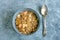 Bowl of oatmeal cereals breakfast with a silver table spoon