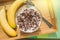 Bowl of oatmeal chocolate flakes in the shape of letters of the alphabet with milk on a wooden tray with bananas, healthy