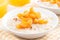 Bowl of oatmeal with fresh apricots and orange juice, close-up