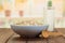 Bowl oatmeal, glass milk, wooden spoon on background of kitchen.