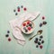 Bowl of oatmeal porridge with berries on blue rustic wooden background