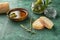 Bowl with olive oil and bread on textured table