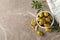 Bowl with olives, leaves and towel on background, space for text