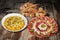 Bowl Of Olivier Salad with Appetizer Meze And Bunch Of Sesame Croissant Puff Pastry Set On Old Weathered Garden Table