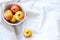 A bowl of organic apples, left of center, on a white background