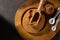 Bowl with organic carob powder on dark rustic wooden background