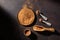 Bowl with organic carob powder on dark rustic wooden background