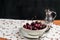 Bowl of organic cherries on a white lace runner