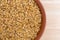 Bowl of organic golden flaxseed on a wood table