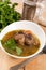 Bowl of ox tail meat soup with barley