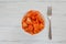 Bowl of papaya fruit on a table, white background