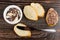 Bowl with paste, pieces of bread, knife, sandwich with chocolate-nut paste on table. Top view