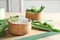 Bowl with peeled aloe vera and green leaves