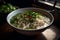 A bowl of pho, Vietnam\\\'s famous rice noodle soup, garnished with cilantro, lime, bean sprouts and chili peppers. Capture the