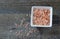 Bowl of Pink Himalayan Salt on a rustic wood plank board with room for copy space