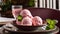 A bowl of pink ice cream with a green leaf on top