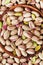 Bowl of pistachio nuts on wooden table from above. Healthy food and snack.