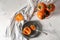 Bowl and plate with ripe persimmons on table, top view