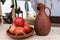 Bowl of pomegranate fruits and earthenware pitcher