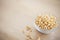 Bowl of pop corn kernels on wooden table