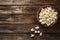 Bowl of popcorn on a dark wooden plank background, a concept of movie time snacks