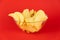 Bowl of potato chips in bright red background. Minimalistic image of attention grabbing fast food in vivid colors