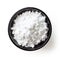 Bowl of powder sugar on white background, from above