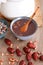 A bowl of prepared Laba porridge and a bowl of multi-grain ingredients on the table and jujube and peanuts scattered on the table